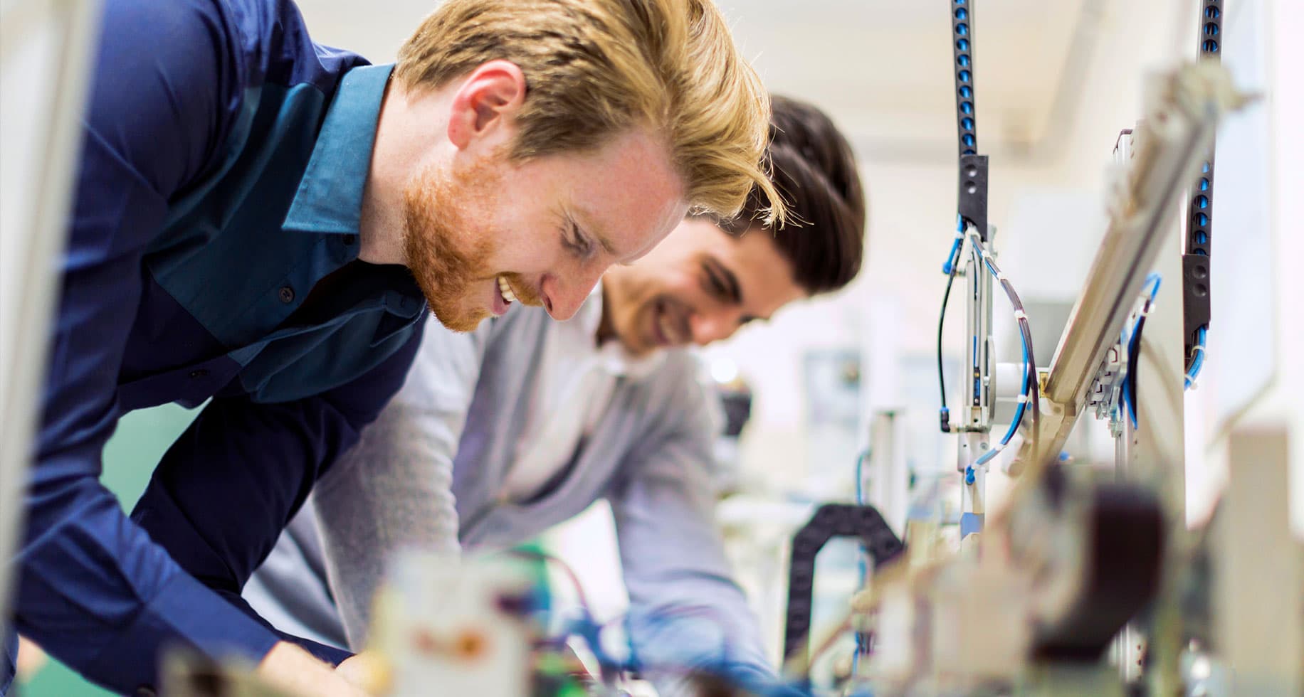 Two engineers working on a problem inside a networking lab